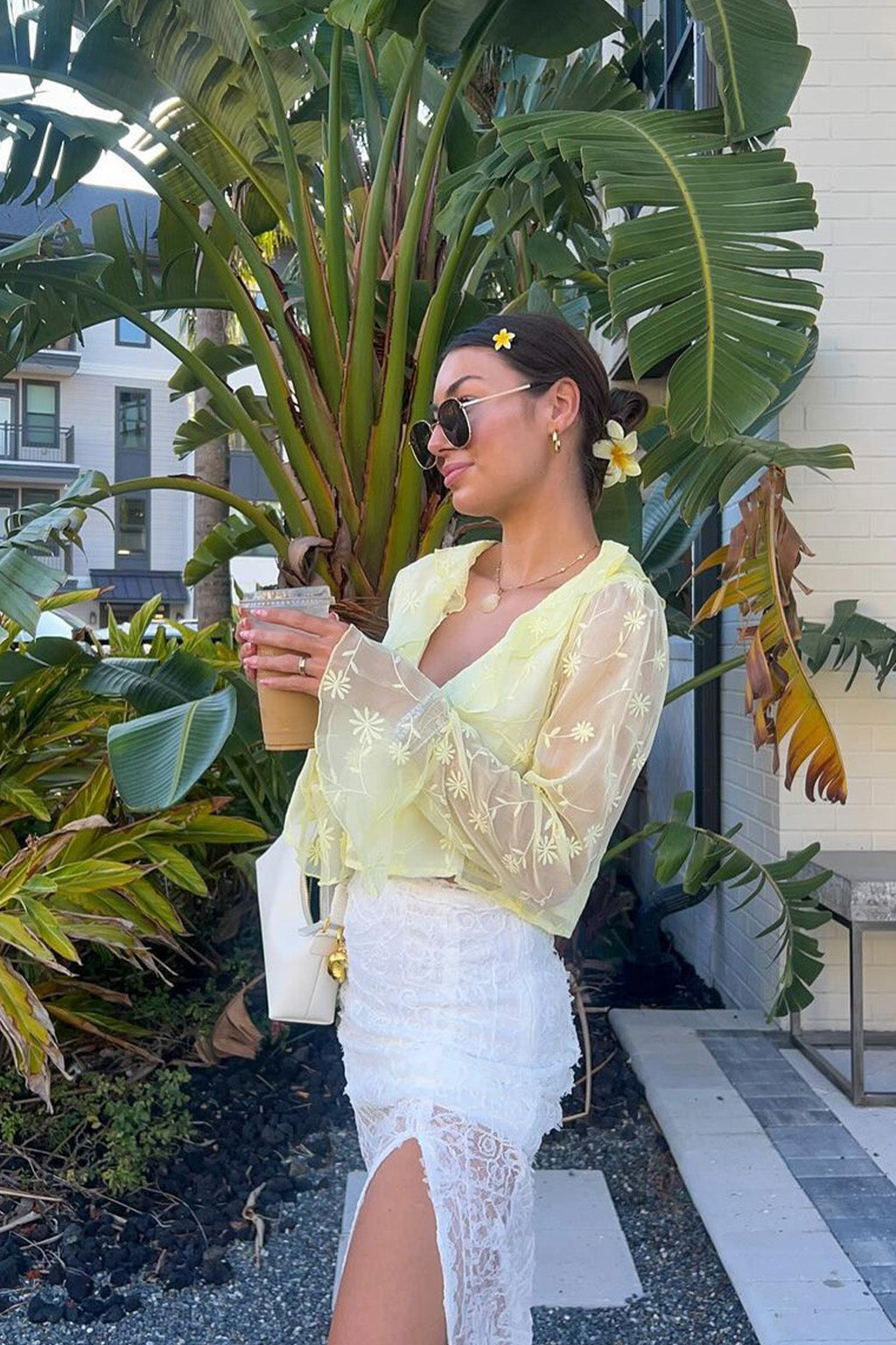Full-length view of the yellow blouse showing the drape and movement.