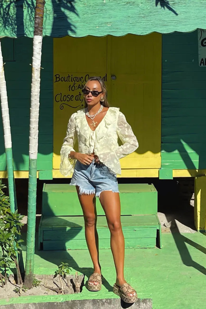 Product view of the Guilliana Yellow Ruffle Blouse showcasing versatility and wearability.