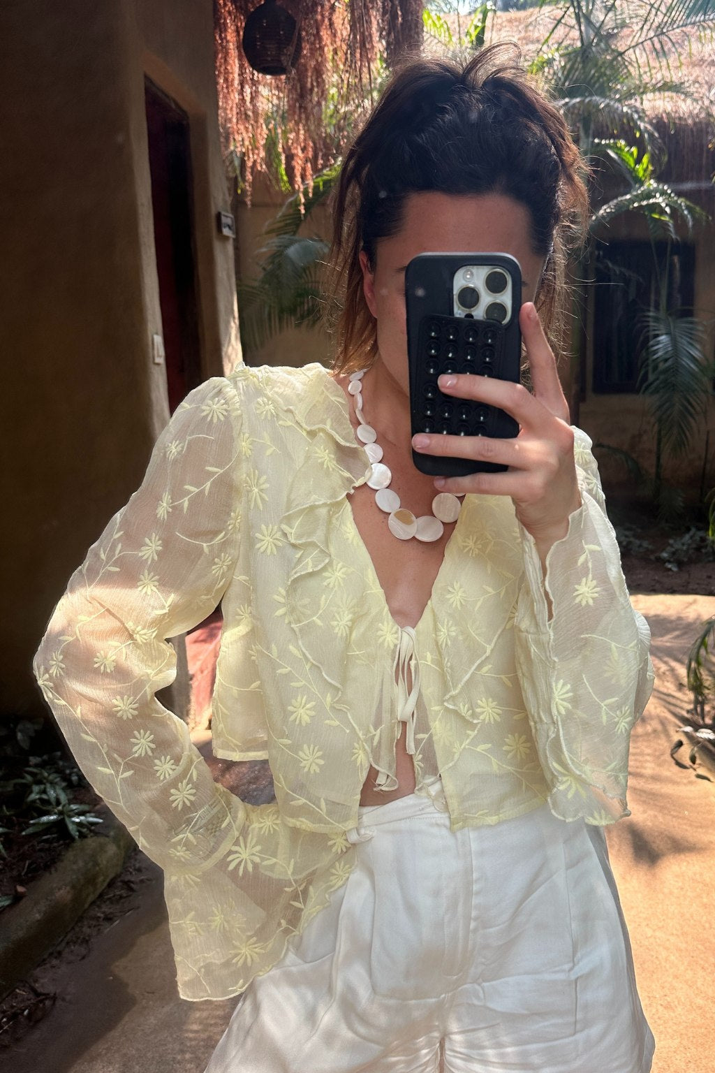 Detail shot of the Guilliana Yellow Ruffle Blouse highlighting the ruffled elements.