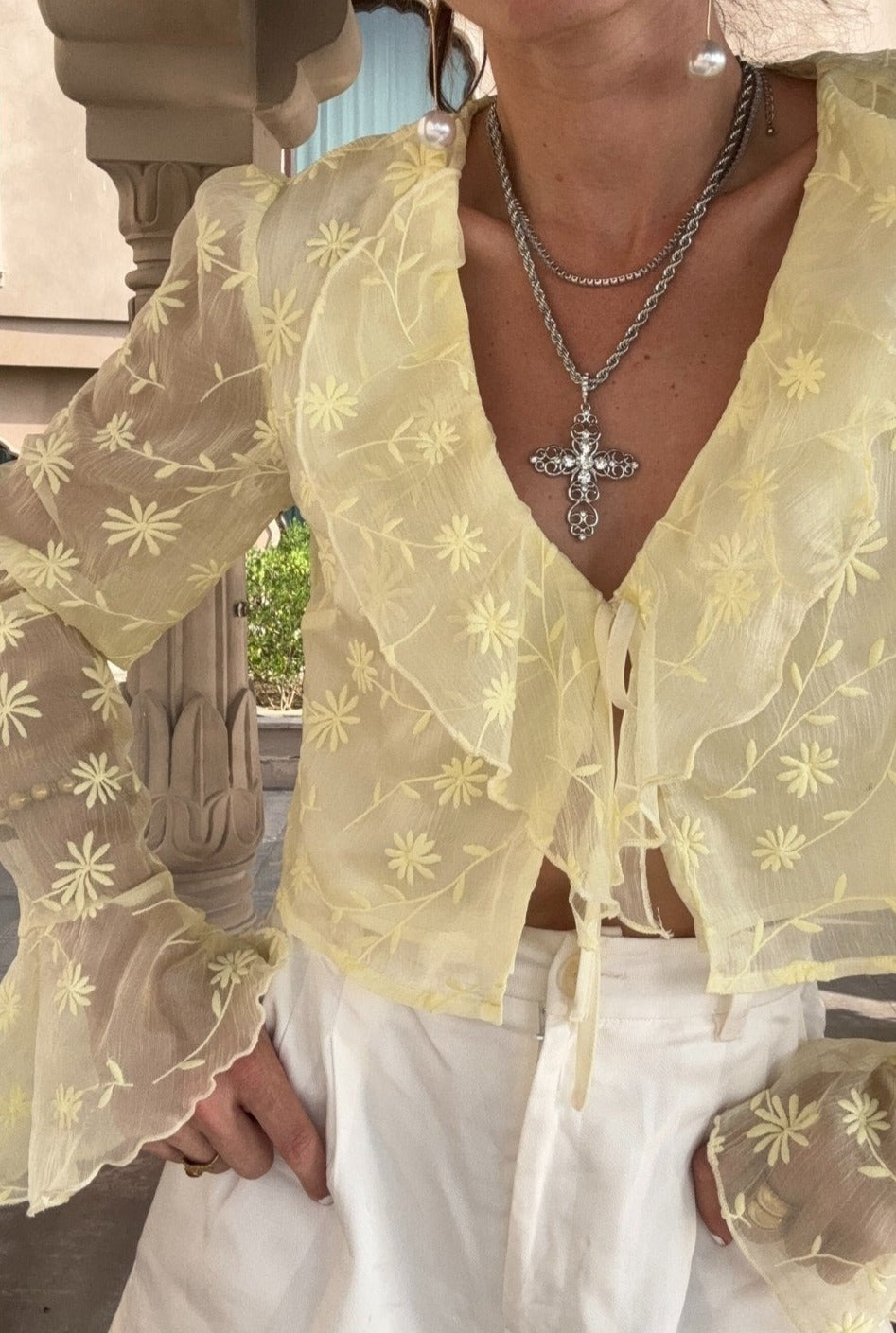 Lifestyle shot of the yellow blouse styled for day-to-night versatility.