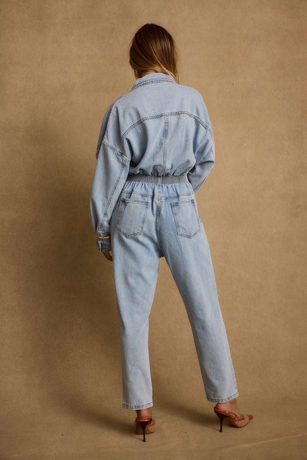 Detail shot of the Hendrix Denim Jumpsuit highlighting the denim elements.