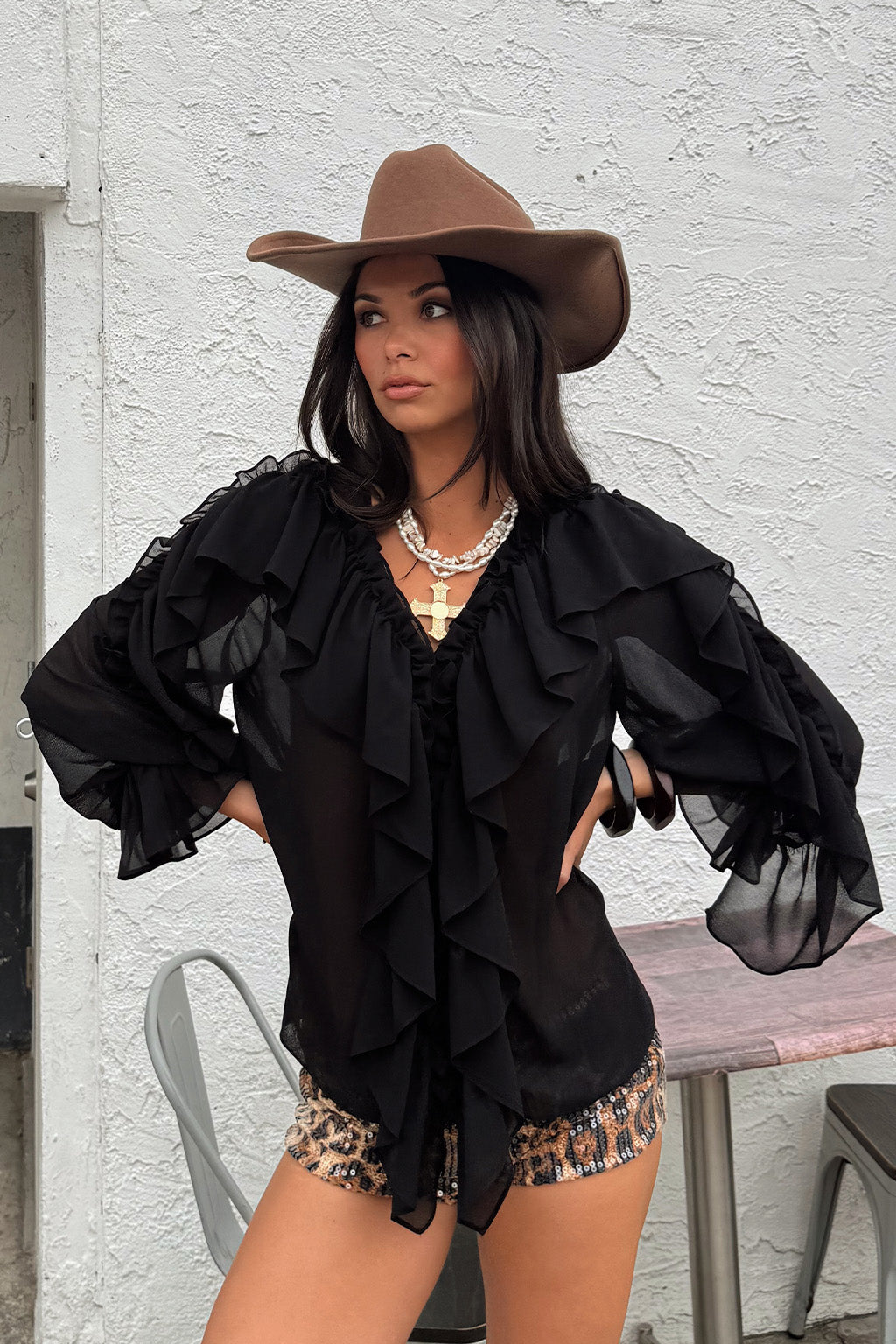 Back view of the black blouse showing the silhouette and fit.