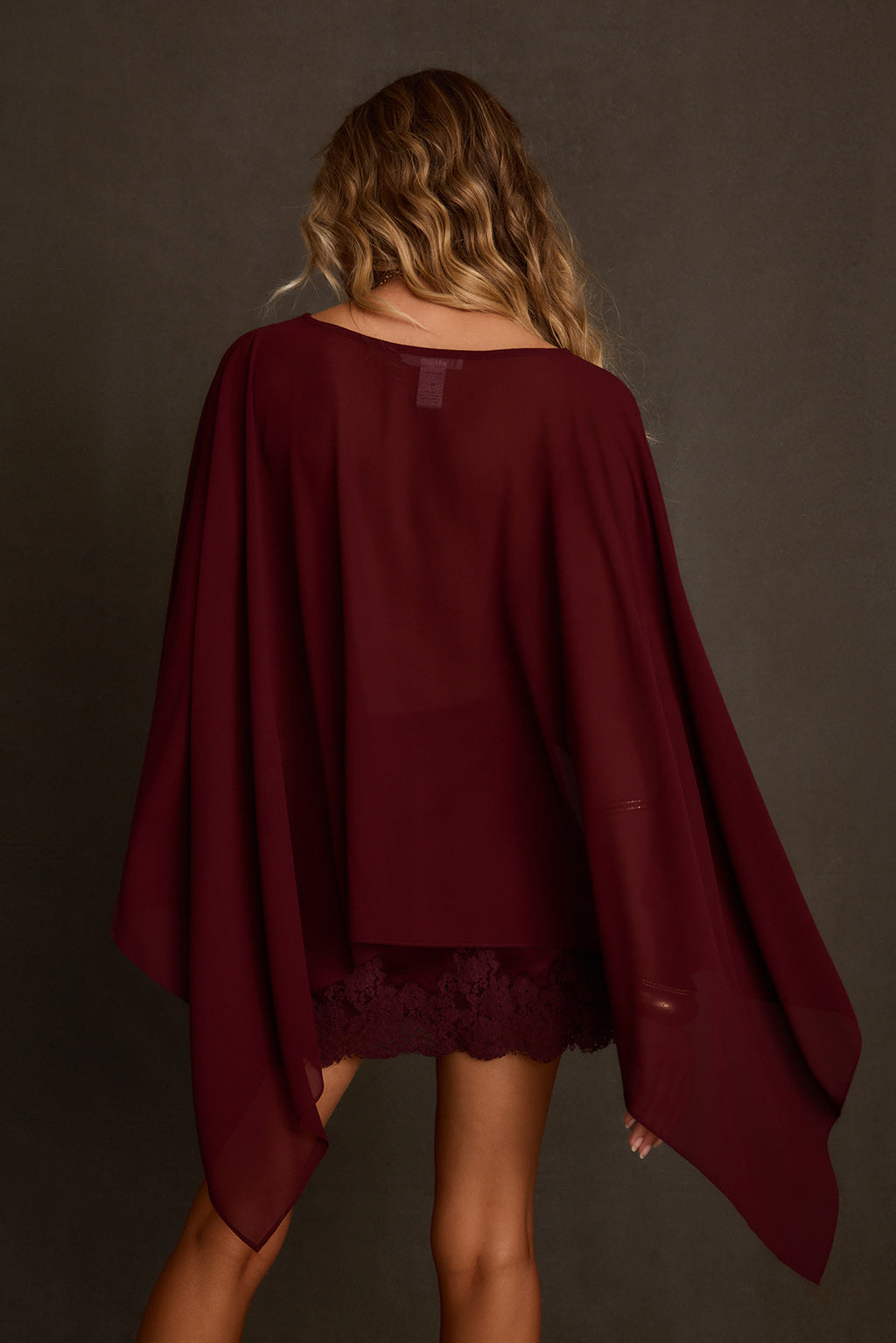 Going out top styled as set with lace-trimmed satin skirt, gold pendant, and bangles