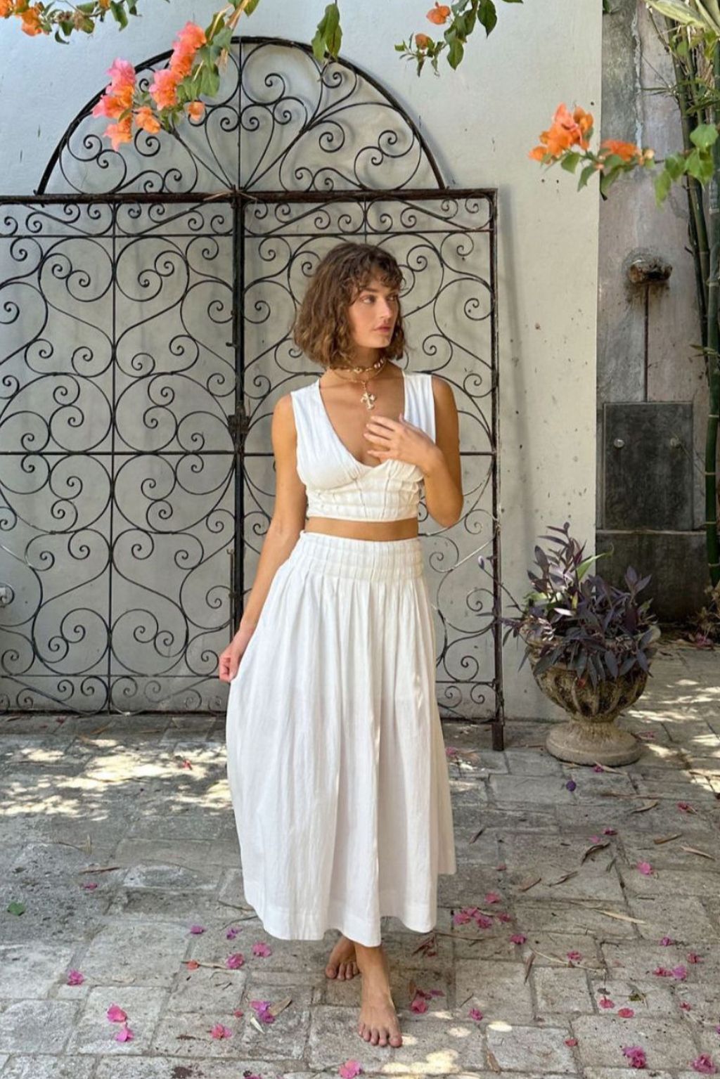 Full-length view of the white maxi skirt showing the drape and movement.