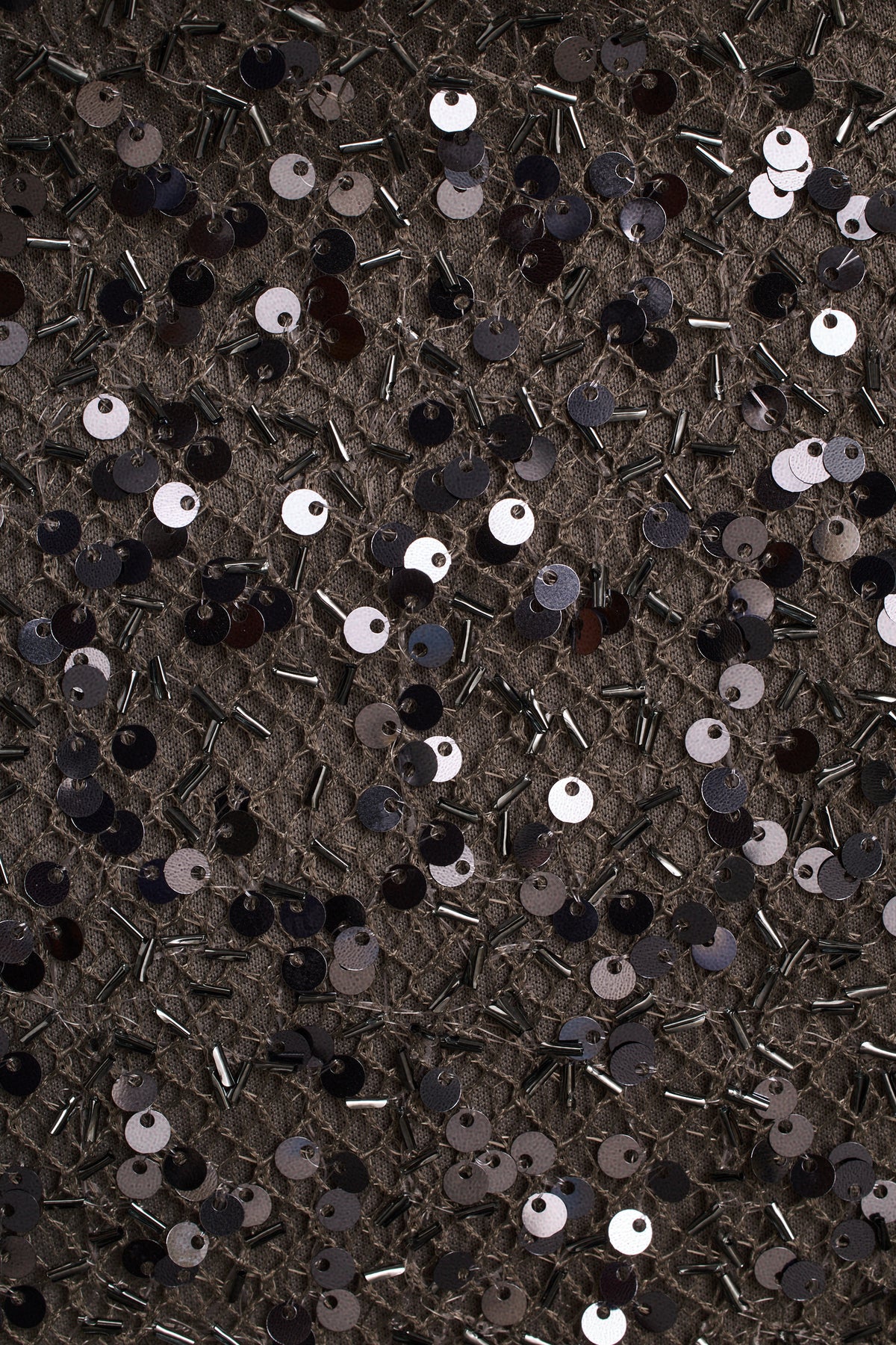 Gunmetal sequin mini dress fabric close-up with black, silver, and white sequins