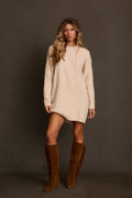 Sweater mini dress in cream cable knit with crew neckline, styled with cognac fringe boots