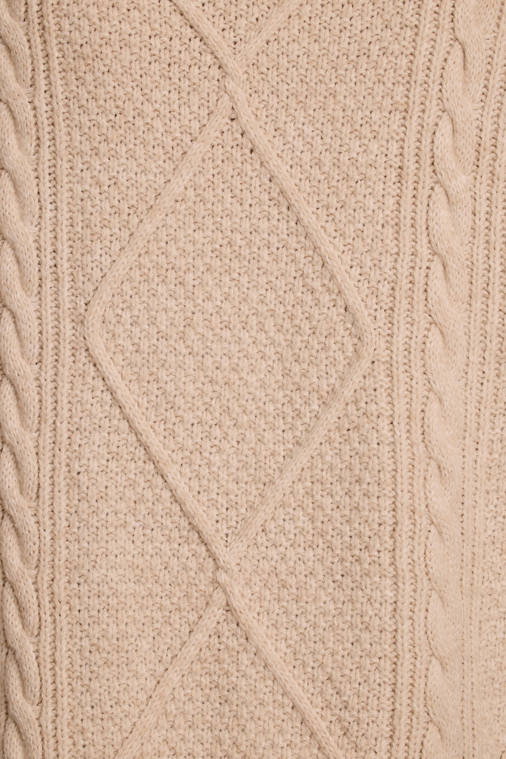 Cable knit dress fabric close-up showing cream yarn texture and diamond knit pattern