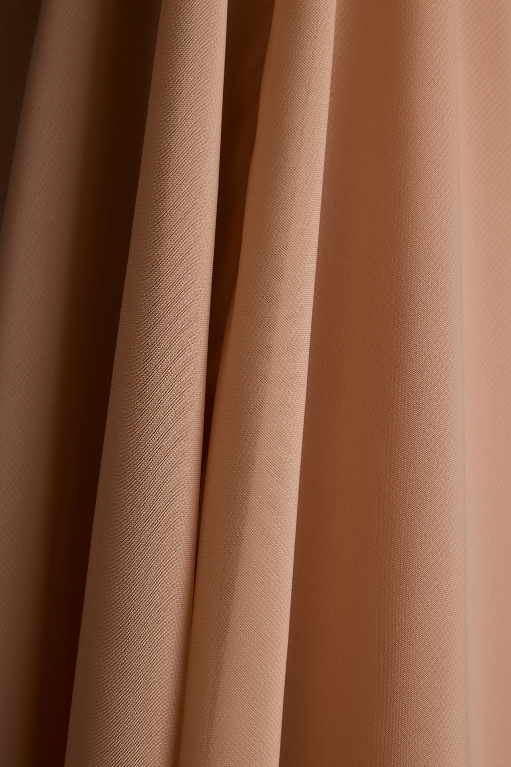 Close-up of draped nude chiffon fabric.