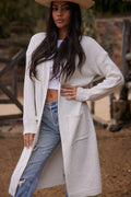 White cardigan with refined detailing and a flattering silhouette.