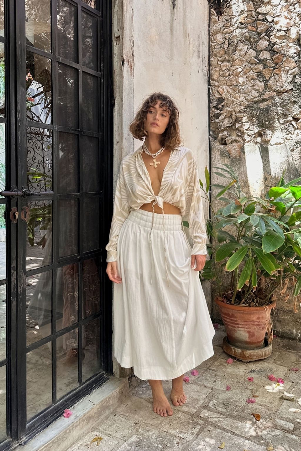 Back view of the beige top showing the silhouette and fit.