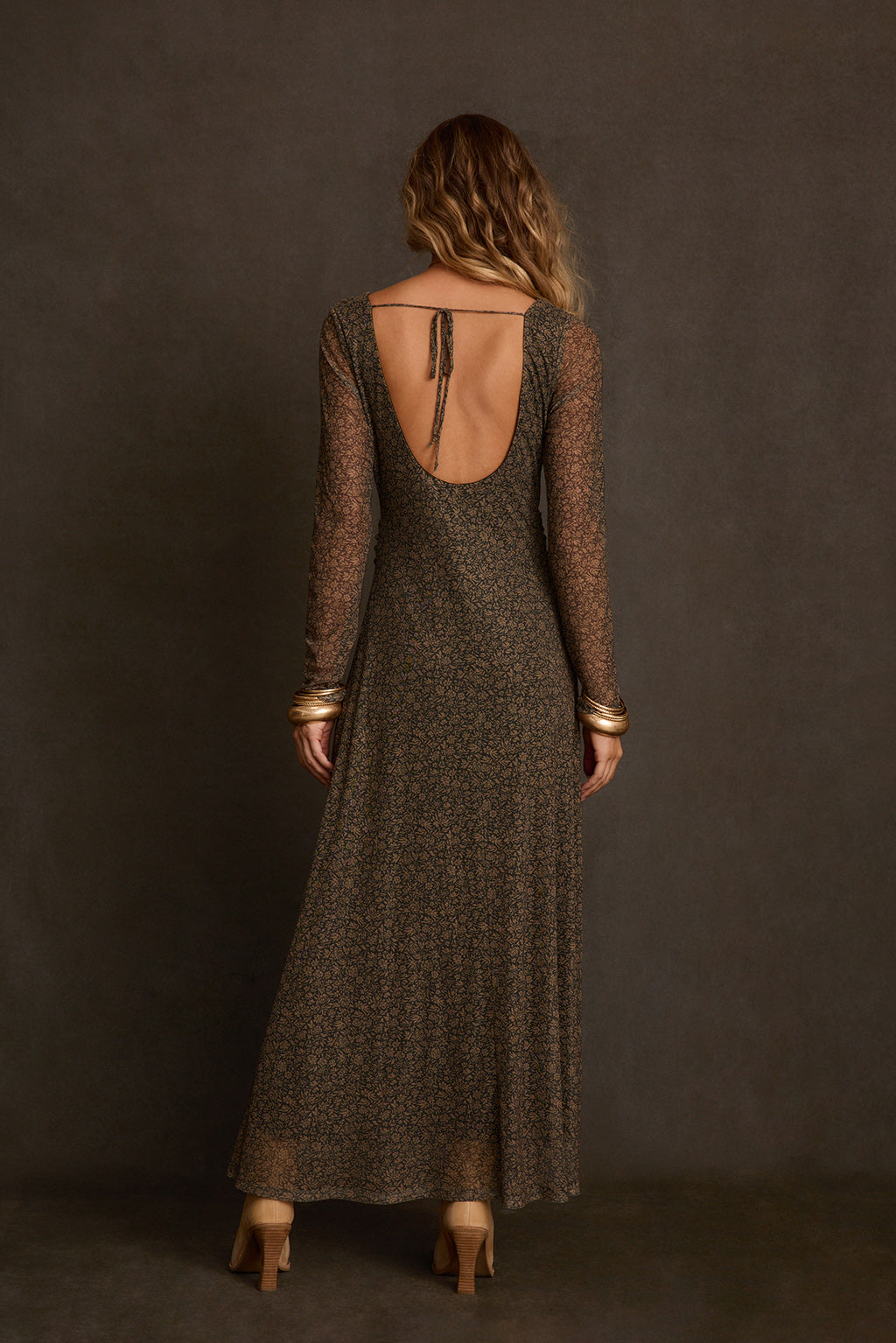 Olive mesh dress full body walking shot on sidewalk with pointed boots