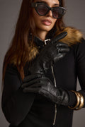 Black vegan leather and leather piece with refined detailing and a flattering silhouette.