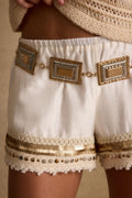 Gold belt with refined detailing and a flattering silhouette.
