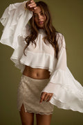 White chiffon ruffled top with refined accents, a white feather top essential.