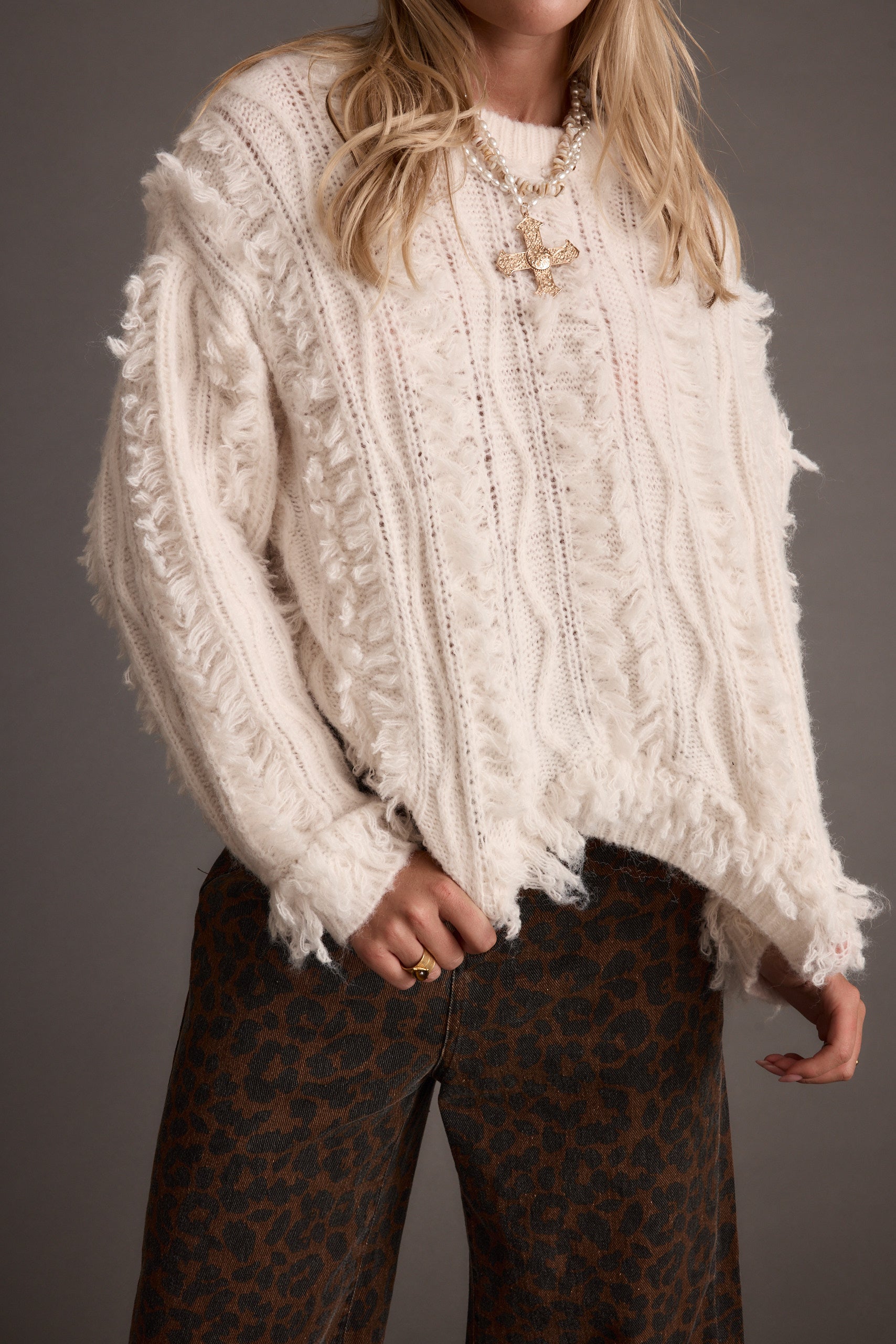 Lorie Beige Fringe Sweater paired with complementary accessories for a polished look.
