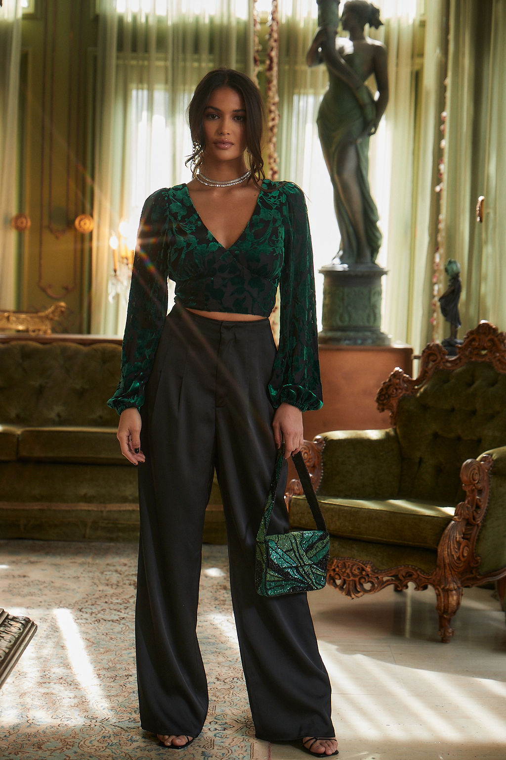 Full-length view of the emerald blouse showing the drape and movement.