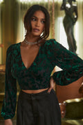 Emerald velvet blouse with refined detailing and a flattering silhouette.