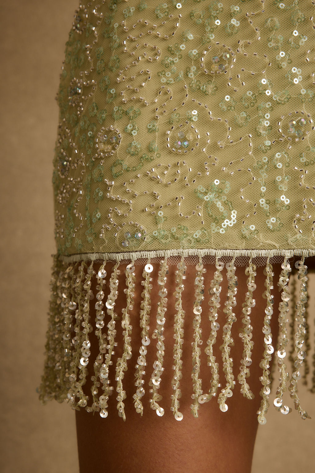 Lifestyle shot of the sage mini skirt styled for day-to-night versatility.