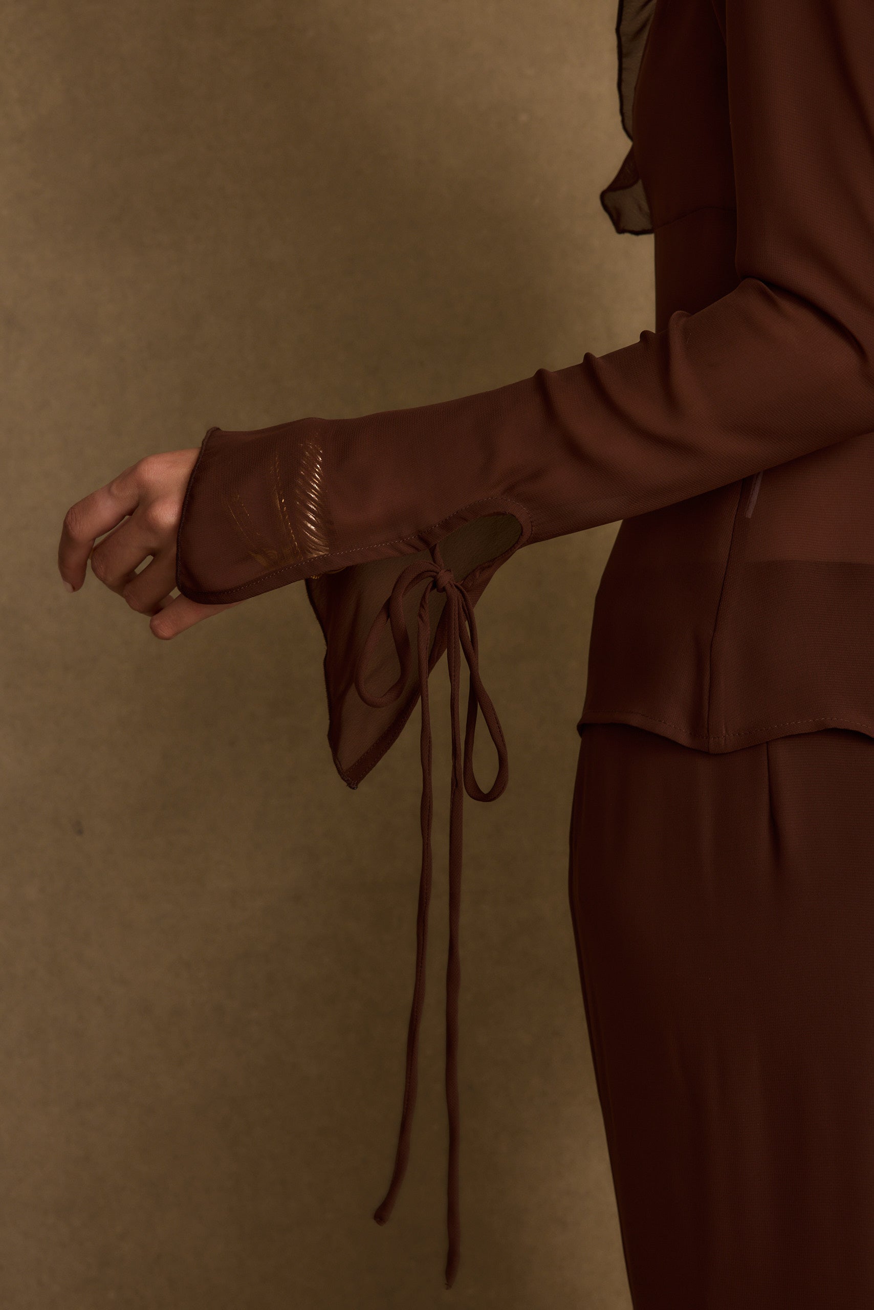 Lifestyle shot of the mocha top styled for day-to-night versatility.