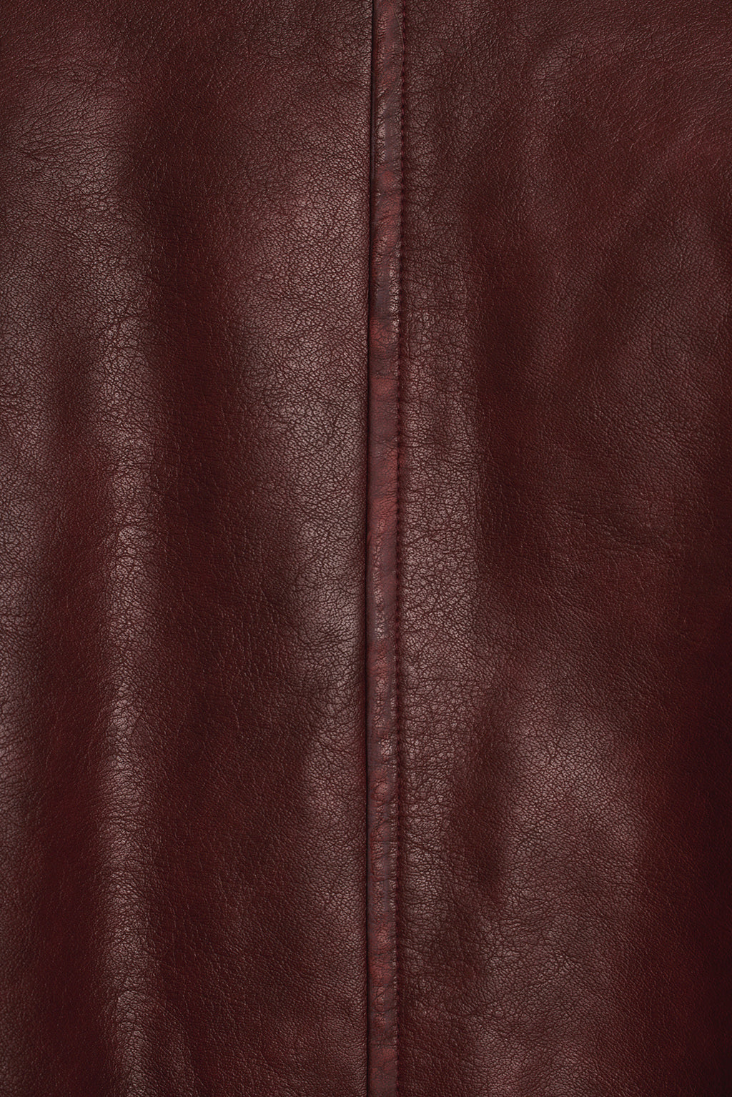Mulberry faux leather fabric close-up showing pebbled texture and stitch detail