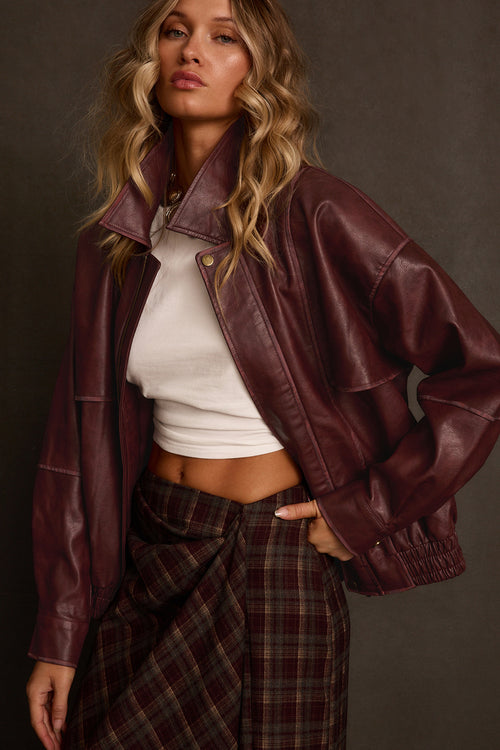 Women's jacket full body front view showing oversized bomber silhouette and snap closure