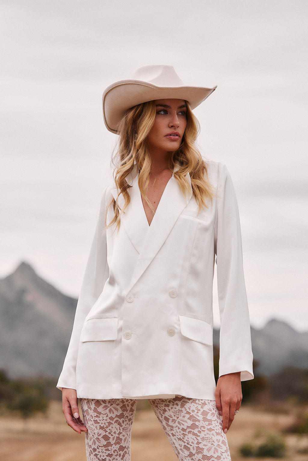 Lifestyle shot of the white blazer styled for day-to-night versatility.