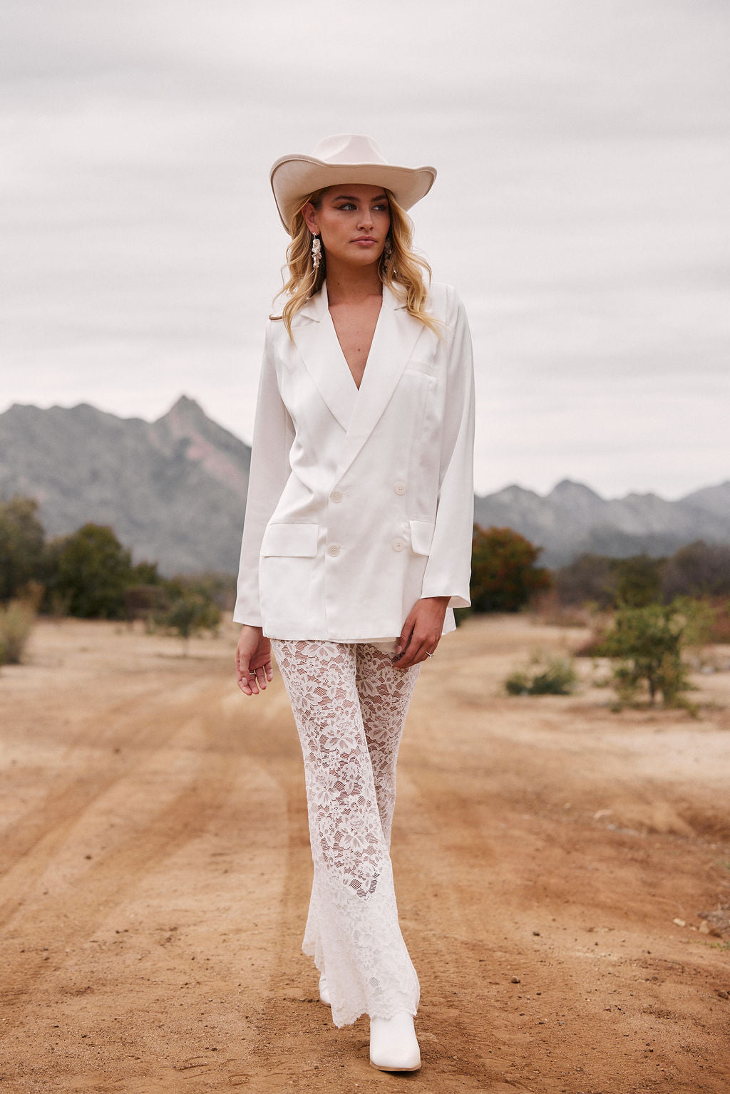 Alternate angle of the white blazer highlighting the overall design.