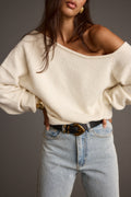 Cream sweater with refined detailing and a flattering silhouette.