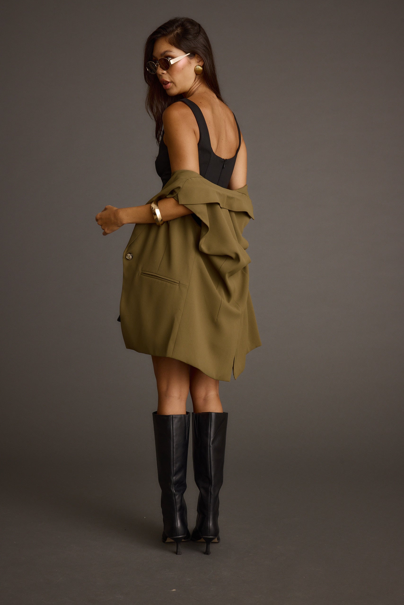 Alternate angle of the olive blazer highlighting the overall design.