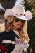 White cowboy hat with elegant accents, a cowboy hat essential.