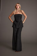 Black trousers with refined detailing and a flattering silhouette.