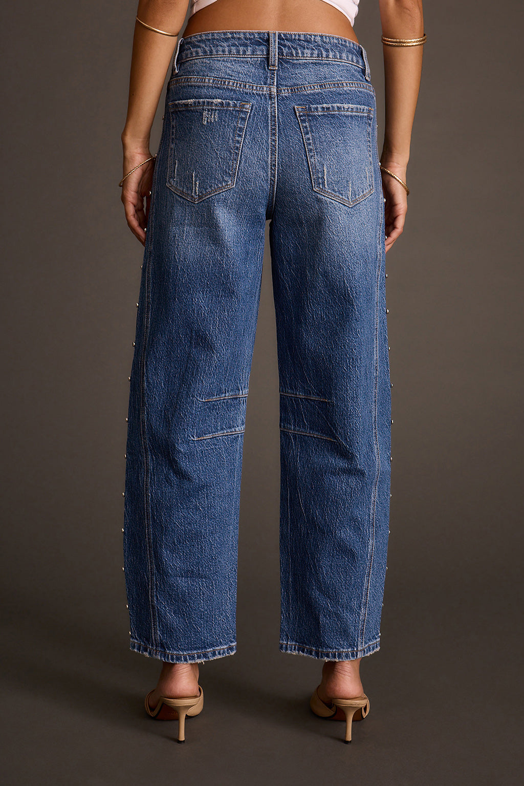 Women's studded barrel jeans with bead embellishments down the sides, back view