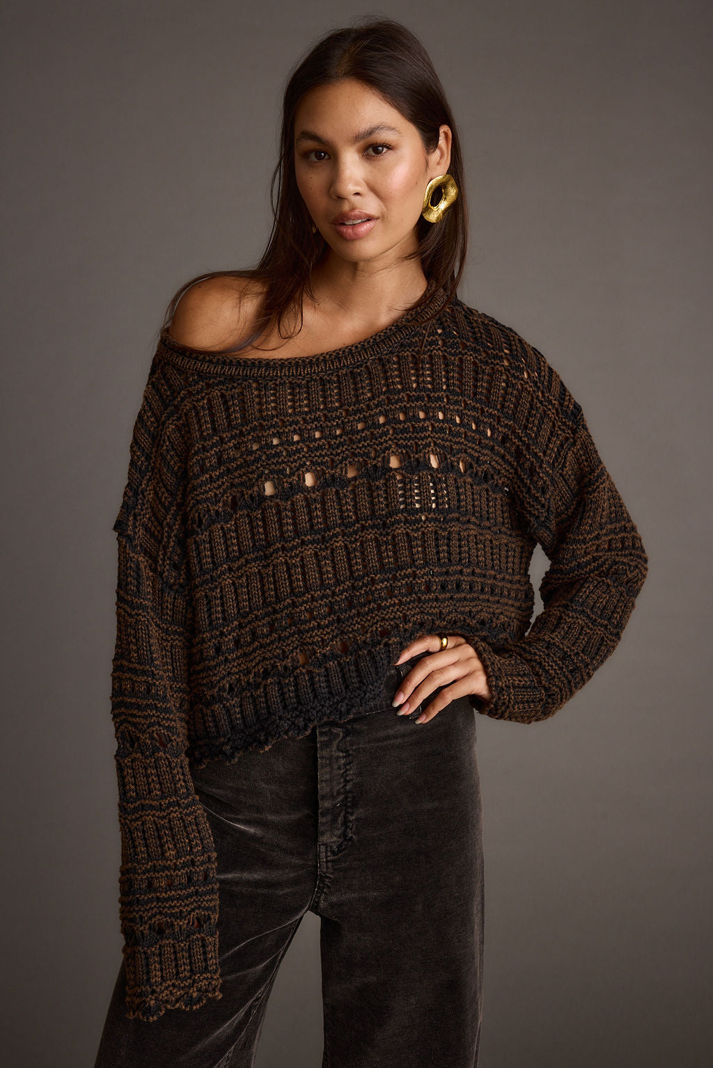 Full-length view of the brown sweater showing the drape and movement.