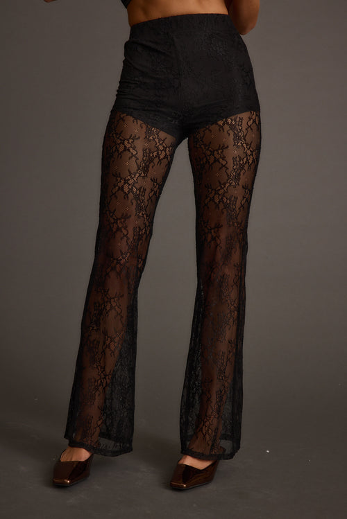 Back view of the black lace pants showing the silhouette and fit.