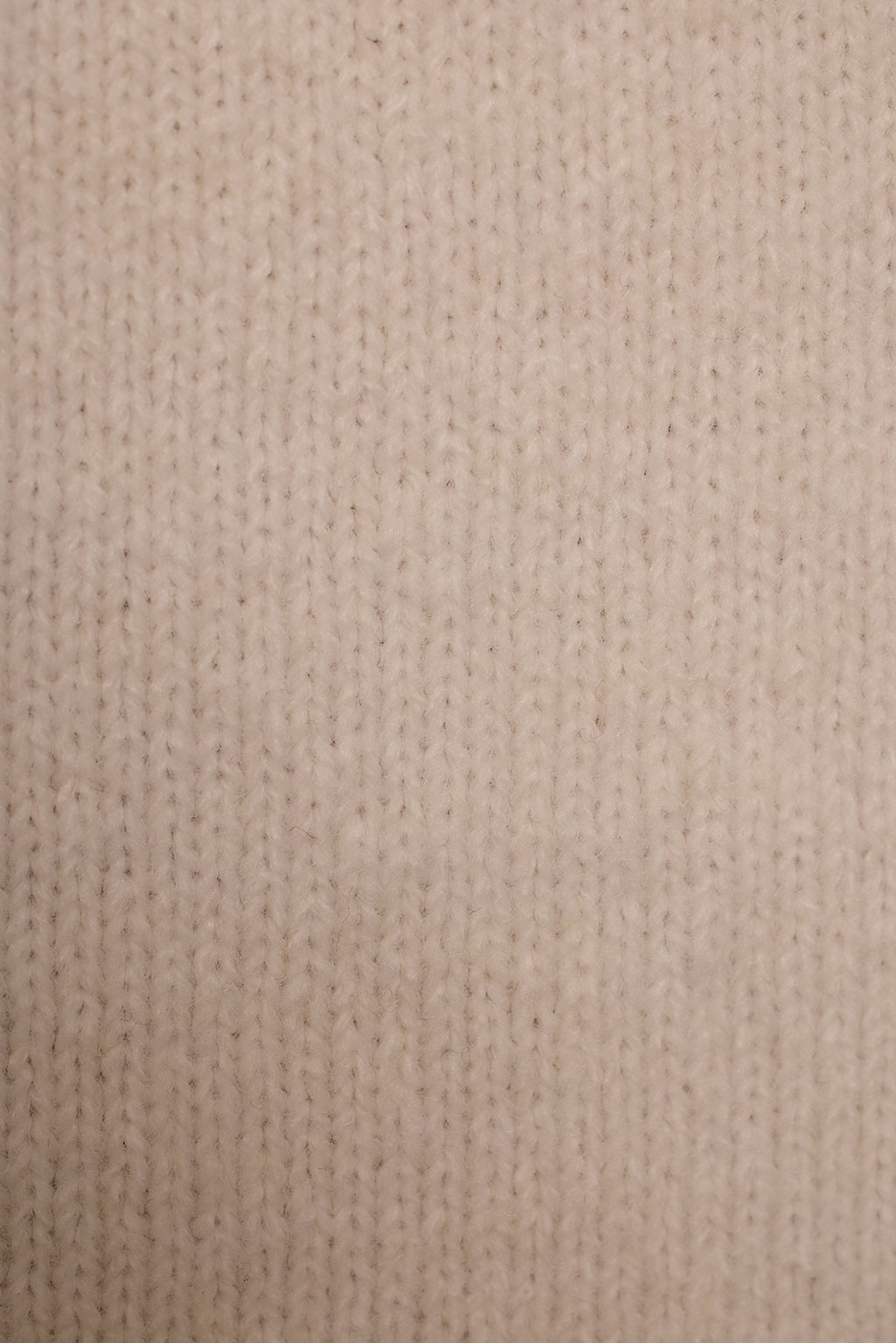 Ivory sleeveless knit fabric detail showing soft fuzzy texture and ribbed collar edge