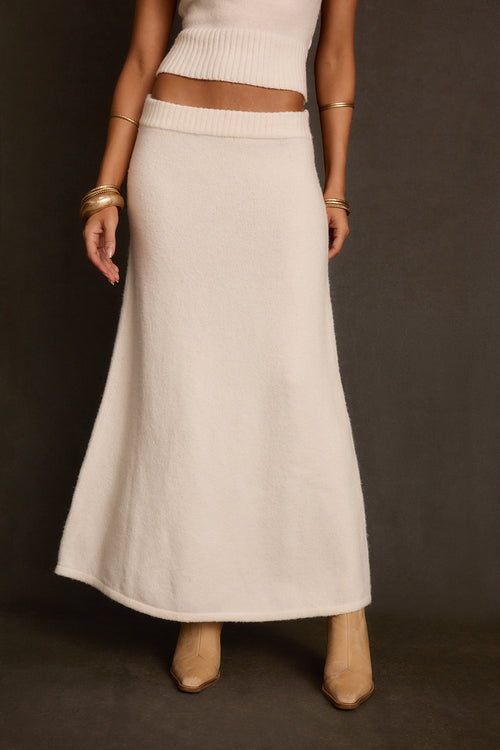 Women's maxi skirt front view in soft ivory knit with ribbed waistband and column shape