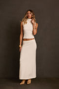 Sweater maxi skirt in ivory styled as matching set with sleeveless turtleneck and boots