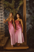 Model wearing the 12th Tribe Mirabella Mulberry Ombre Maxi Dress, featuring a flowing maxi silhouette with a gradient mulberry ombre effect and a flattering tailored fit, styled with strappy heels and delicate jewelry for weddings, brunches, and evening events