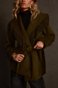 Belted coat in olive with rope fringe collar detail, styled over black turtleneck with gold earrings