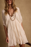 Ivory mini dress with elegant accents, a sequin mini dress essential.