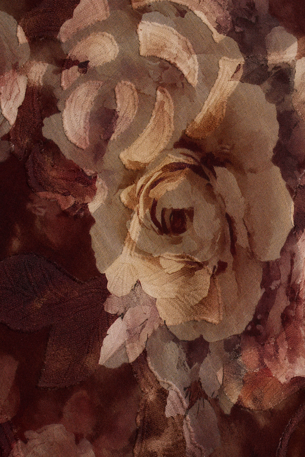 Close-up of a rose floral print on sheer chiffon fabric.