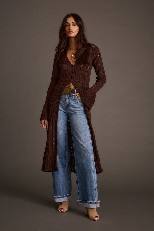 Women's espresso knit longline cardigan styled with wide-leg jeans and nude heels