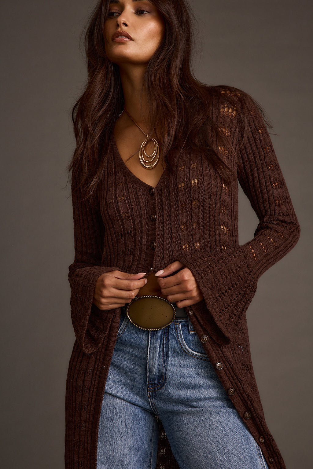 Women's espresso knit longline cardigan styled with a belt and layered necklace