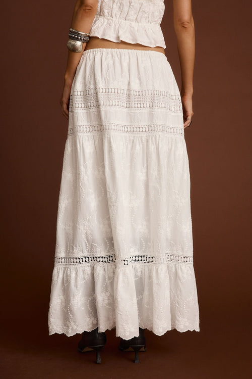 Back view of the white embroidered maxi skirt showing the silhouette and fit.