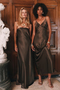 Bronze strapless satin maxi dress and bronze V-neck satin slip midi dress styled with gold jewelry.