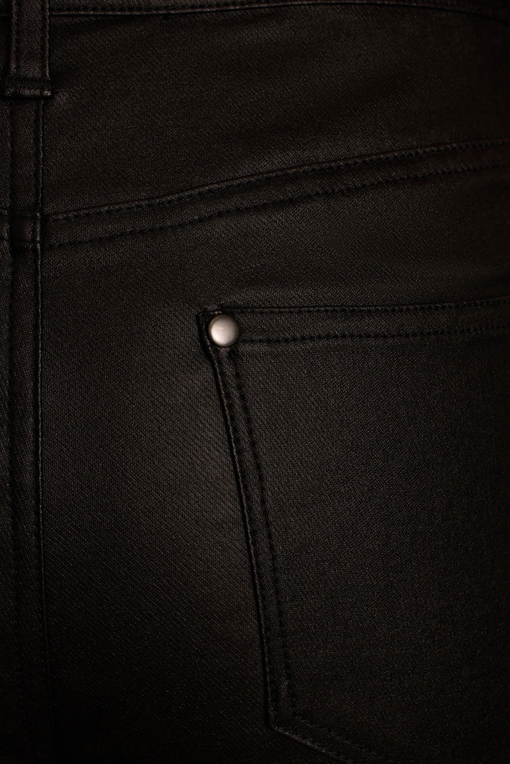 Straight leg pants fabric detail showing coated finish texture on black material