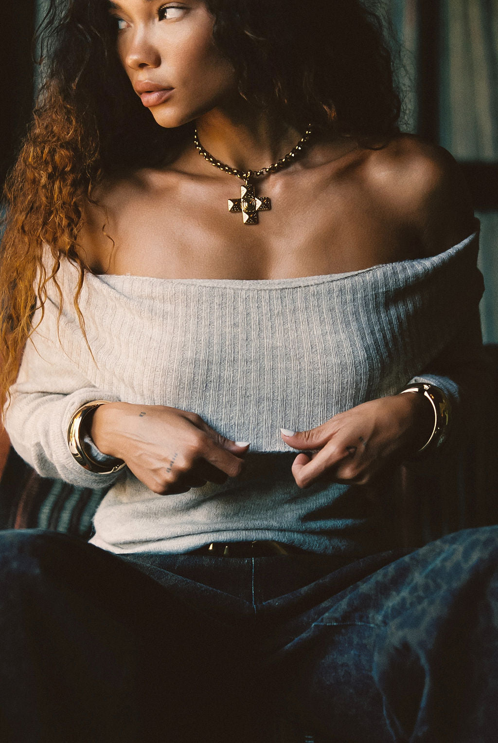 Lifestyle shot of the beige sweater styled for day-to-night versatility.