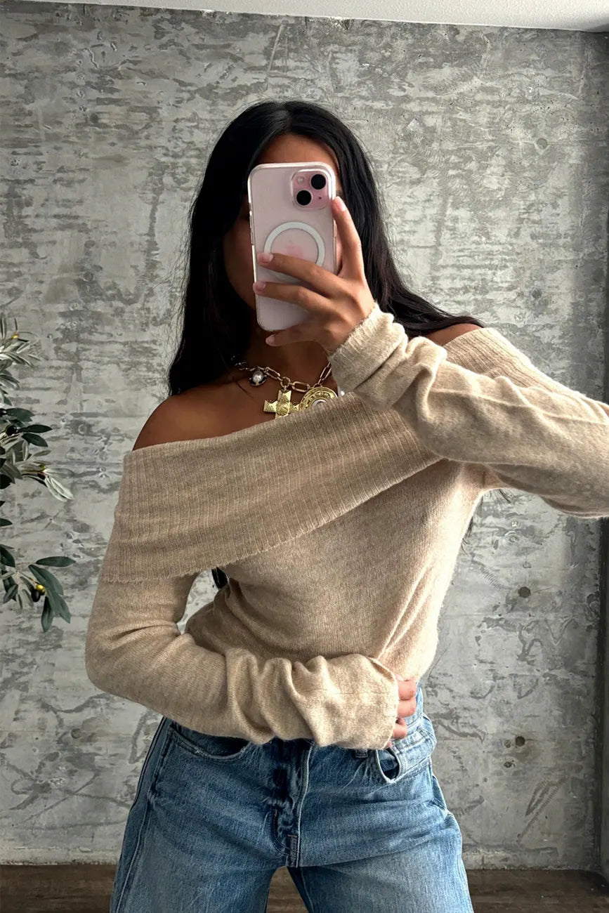 Back view of the beige sweater showing the silhouette and fit.