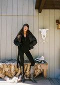 Black ribbed jumpsuit with ribbed detailing and a flattering silhouette.