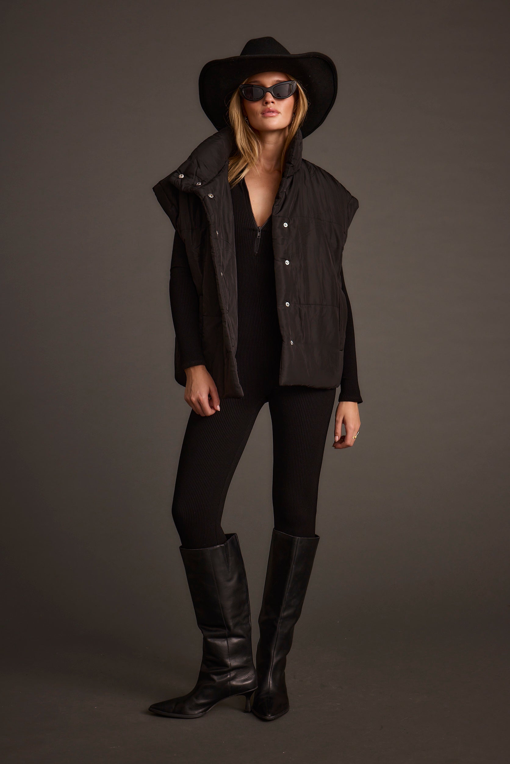 Lifestyle shot of the black jumpsuit styled for day-to-night versatility.